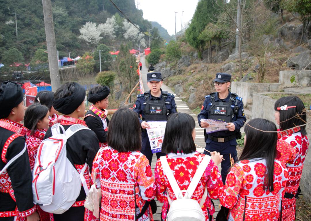 圖2 民警們手拿禁毒、反詐、防火防盜宣傳品開展宣傳.jpg